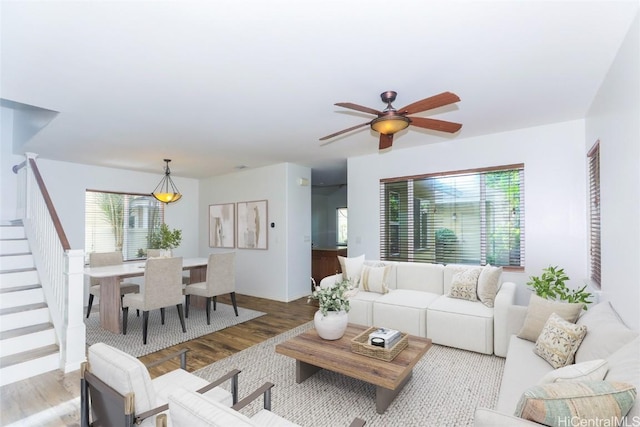 living room featuring ceiling fan and light hardwood / wood-style floors