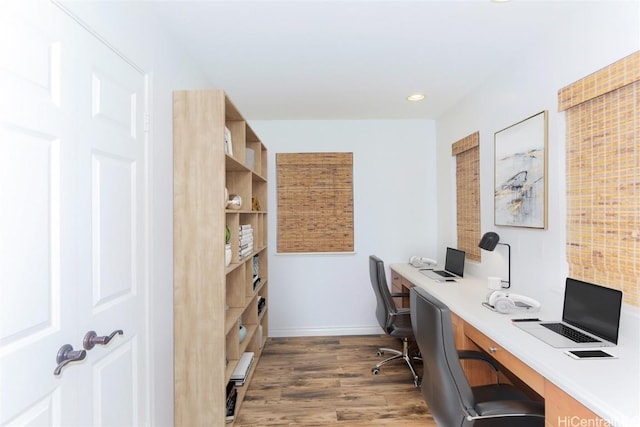 office with dark hardwood / wood-style flooring