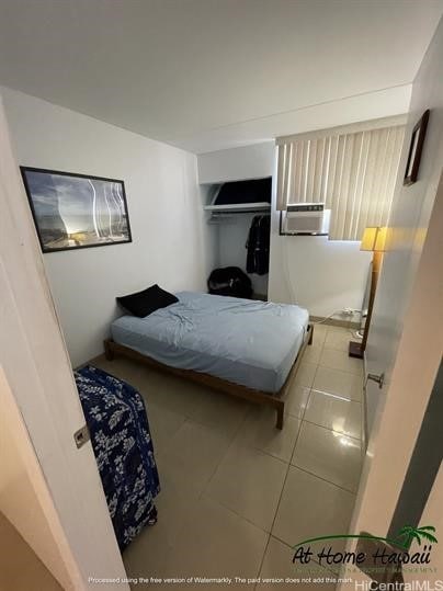 tiled bedroom with a closet