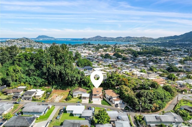 birds eye view of property with a water and mountain view