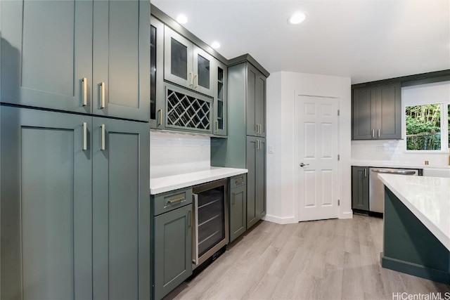 kitchen with dishwasher, light hardwood / wood-style flooring, tasteful backsplash, light stone counters, and beverage cooler