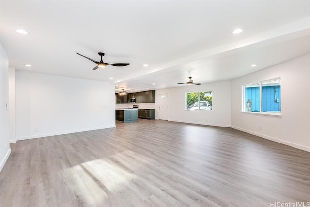 unfurnished living room featuring light wood-type flooring and ceiling fan