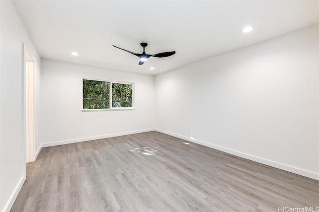 empty room with ceiling fan and light wood-type flooring