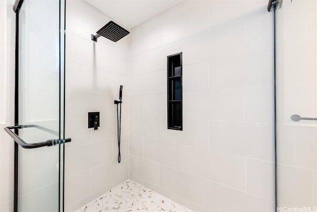 bathroom featuring a shower with door