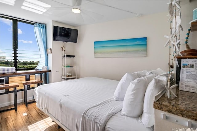 bedroom with ceiling fan and light hardwood / wood-style flooring