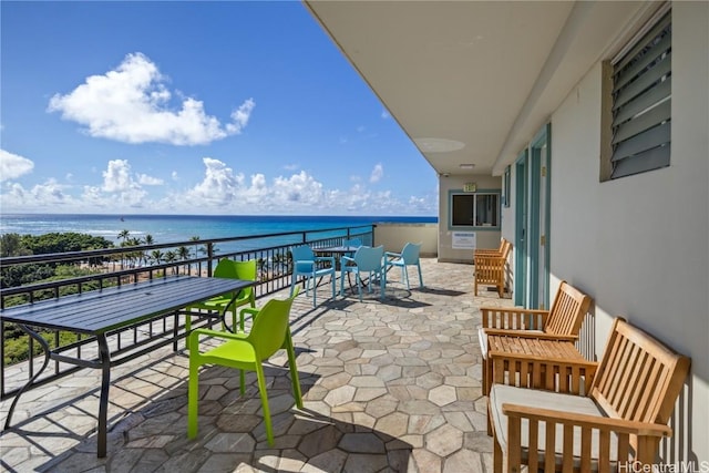 view of patio / terrace featuring a water view and a balcony