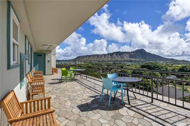 view of patio / terrace featuring a mountain view and a balcony