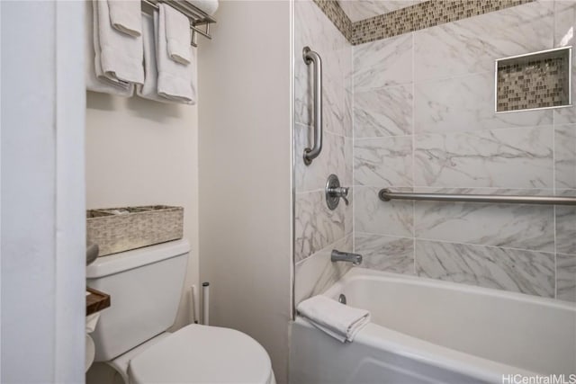 bathroom featuring toilet and tiled shower / bath