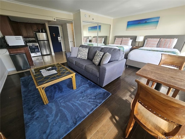 living room with dark hardwood / wood-style flooring and ornamental molding