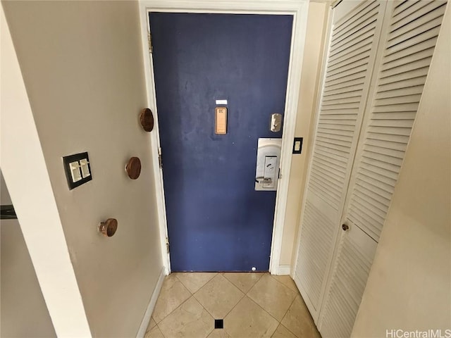 entryway with light tile patterned floors