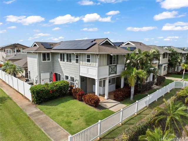 multi unit property with a front yard and solar panels