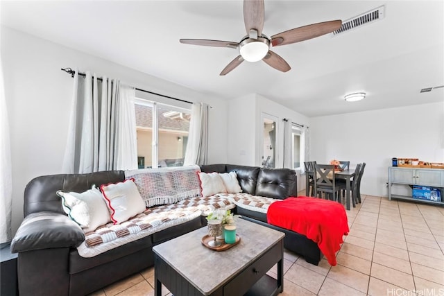 tiled living room with ceiling fan