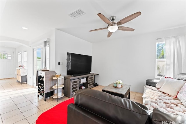 tiled living room featuring ceiling fan