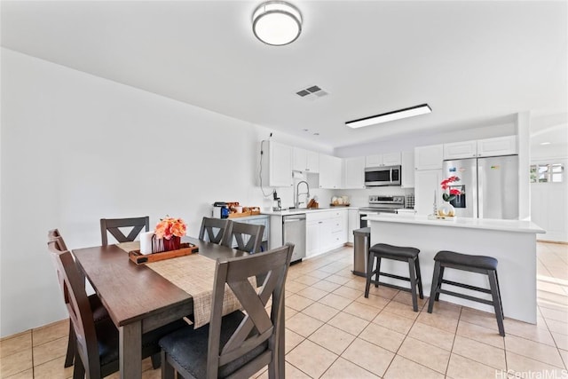 tiled dining area featuring sink