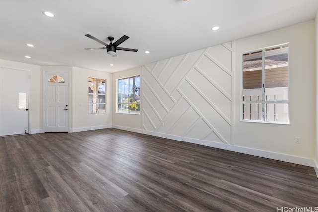 unfurnished living room featuring dark hardwood / wood-style floors and ceiling fan