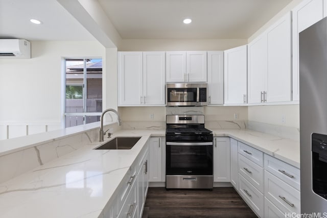 kitchen featuring white cabinets, light stone countertops, sink, and appliances with stainless steel finishes