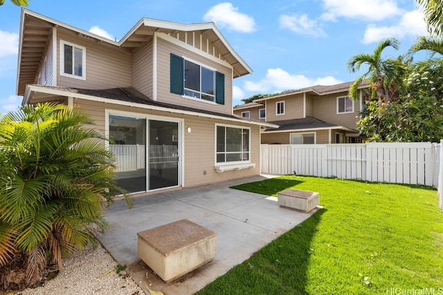 rear view of property with a yard and a patio area