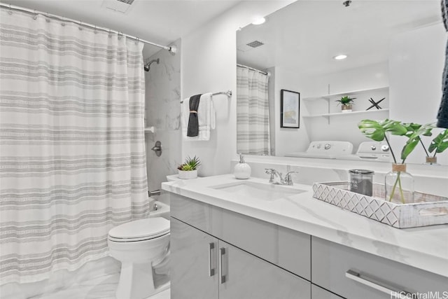 full bathroom with washer and dryer, vanity, toilet, and shower / bath combo with shower curtain