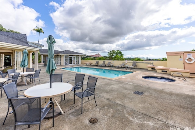 view of pool featuring a patio area and a hot tub