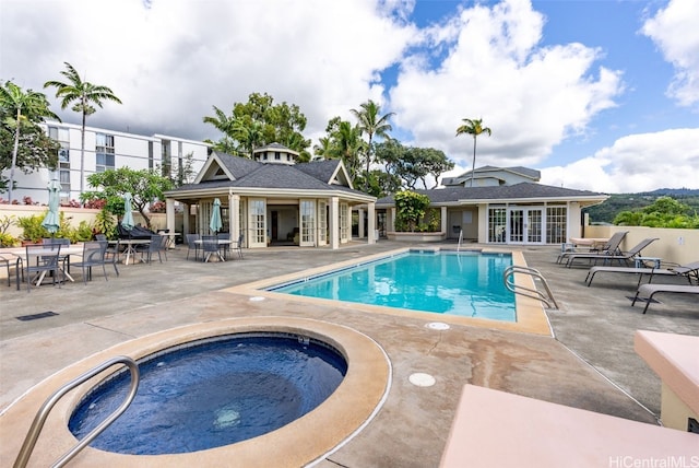 view of pool with a patio area and a community hot tub