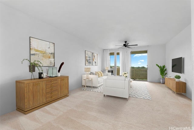 living room with ceiling fan and light colored carpet