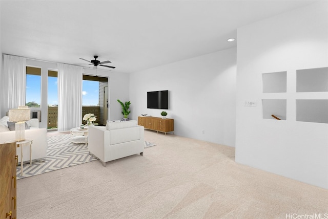 living room with light carpet and ceiling fan