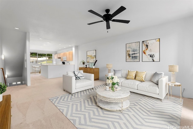 living room featuring light colored carpet and ceiling fan