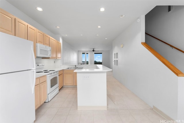 kitchen with light brown cabinets, white appliances, sink, ceiling fan, and a kitchen island