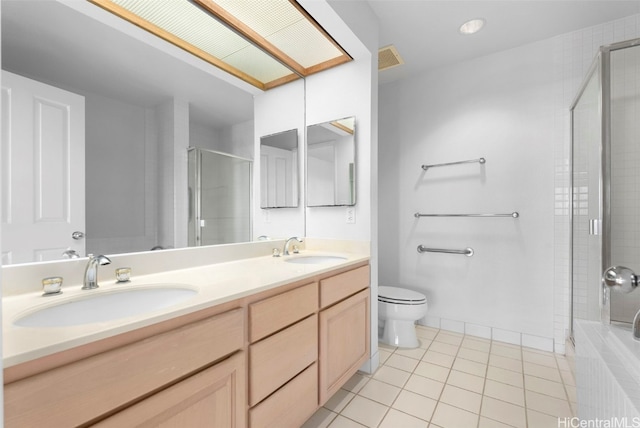 full bathroom featuring plus walk in shower, vanity, tile patterned floors, and toilet