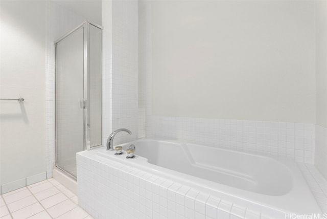 bathroom with tile patterned flooring and independent shower and bath