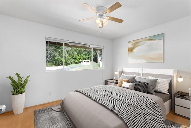 bedroom with ceiling fan and light hardwood / wood-style flooring