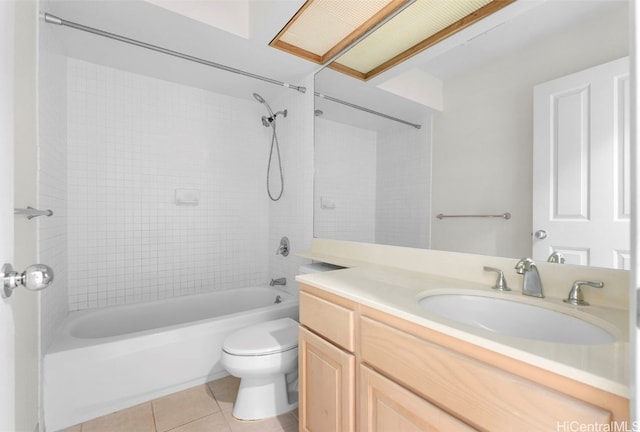 full bathroom featuring tile patterned flooring, vanity, toilet, and tiled shower / bath combo