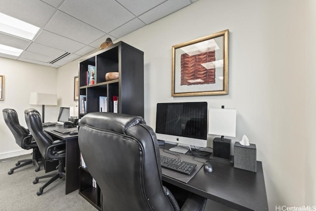 carpeted home office with a drop ceiling