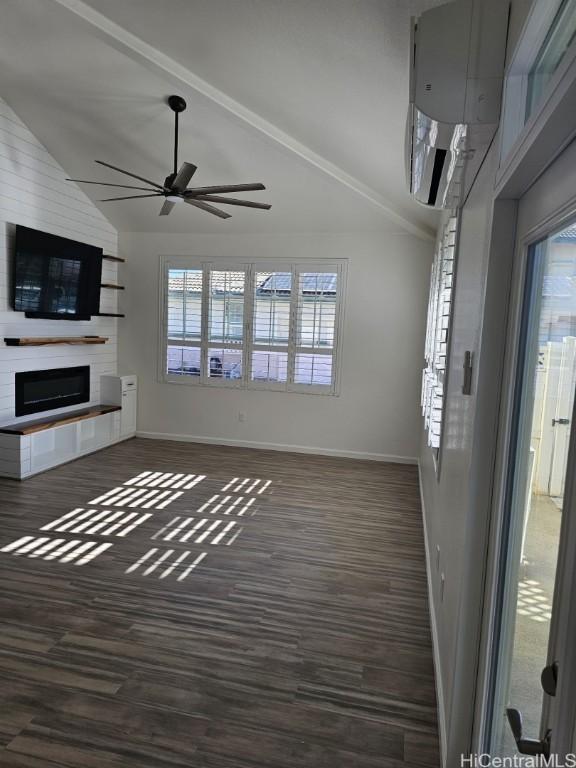 unfurnished living room featuring ceiling fan, a large fireplace, lofted ceiling, and dark wood-type flooring