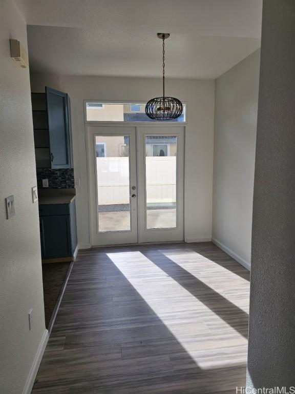 interior space featuring a chandelier, french doors, and dark hardwood / wood-style flooring