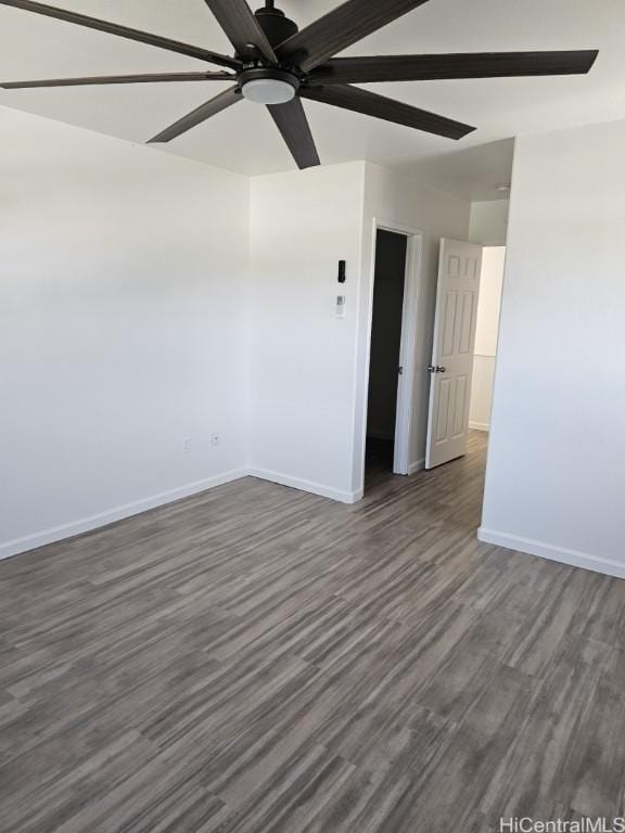 spare room featuring ceiling fan and dark wood-type flooring