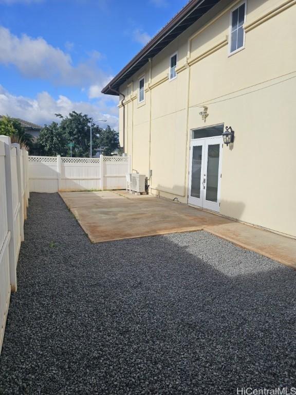 view of yard featuring a patio area, french doors, and central AC