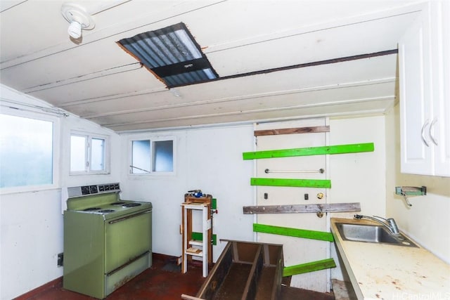 kitchen featuring white electric range oven, white cabinetry, lofted ceiling, and sink