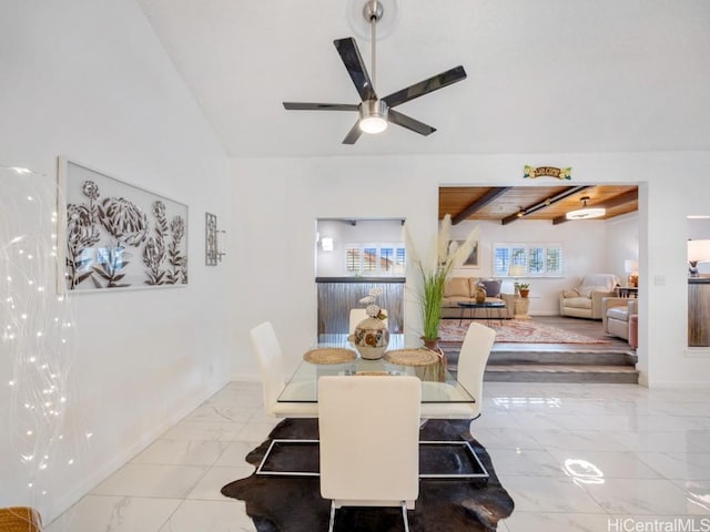 dining space featuring ceiling fan, beamed ceiling, and wooden ceiling