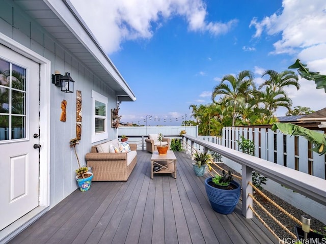 wooden deck with an outdoor living space and a water view