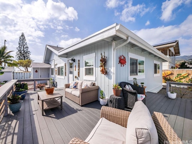 deck with outdoor lounge area and a storage shed