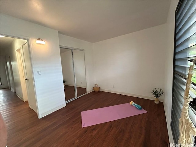 workout area with dark hardwood / wood-style floors