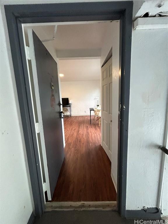 hall with dark hardwood / wood-style flooring