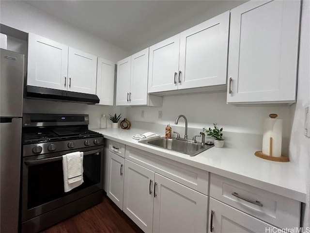 kitchen with white cabinetry, sink, appliances with stainless steel finishes, and dark wood-type flooring