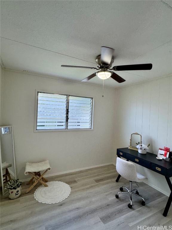 office featuring a ceiling fan, a textured ceiling, baseboards, and wood finished floors