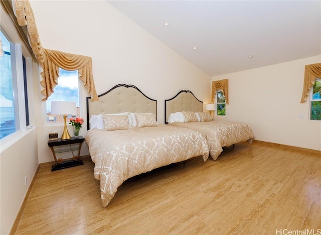 bedroom featuring hardwood / wood-style flooring and vaulted ceiling