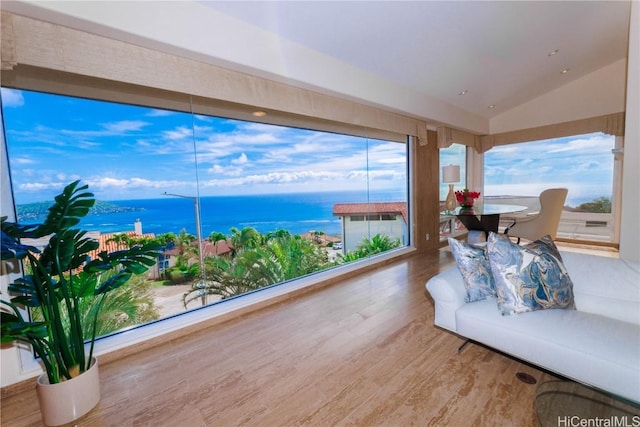 sunroom featuring a water view and lofted ceiling