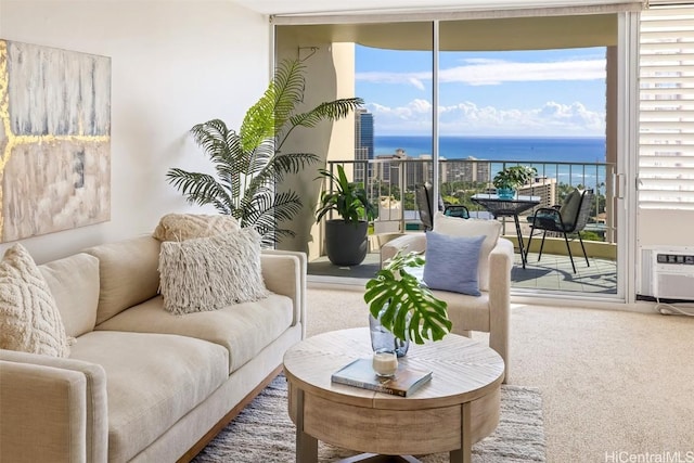 living room with a water view, expansive windows, and carpet floors