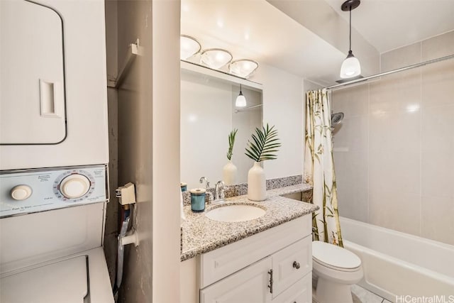 full bathroom featuring stacked washer and dryer, vanity, toilet, and shower / bath combo