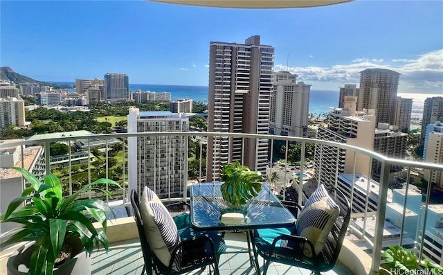 balcony featuring a view of city and a water view